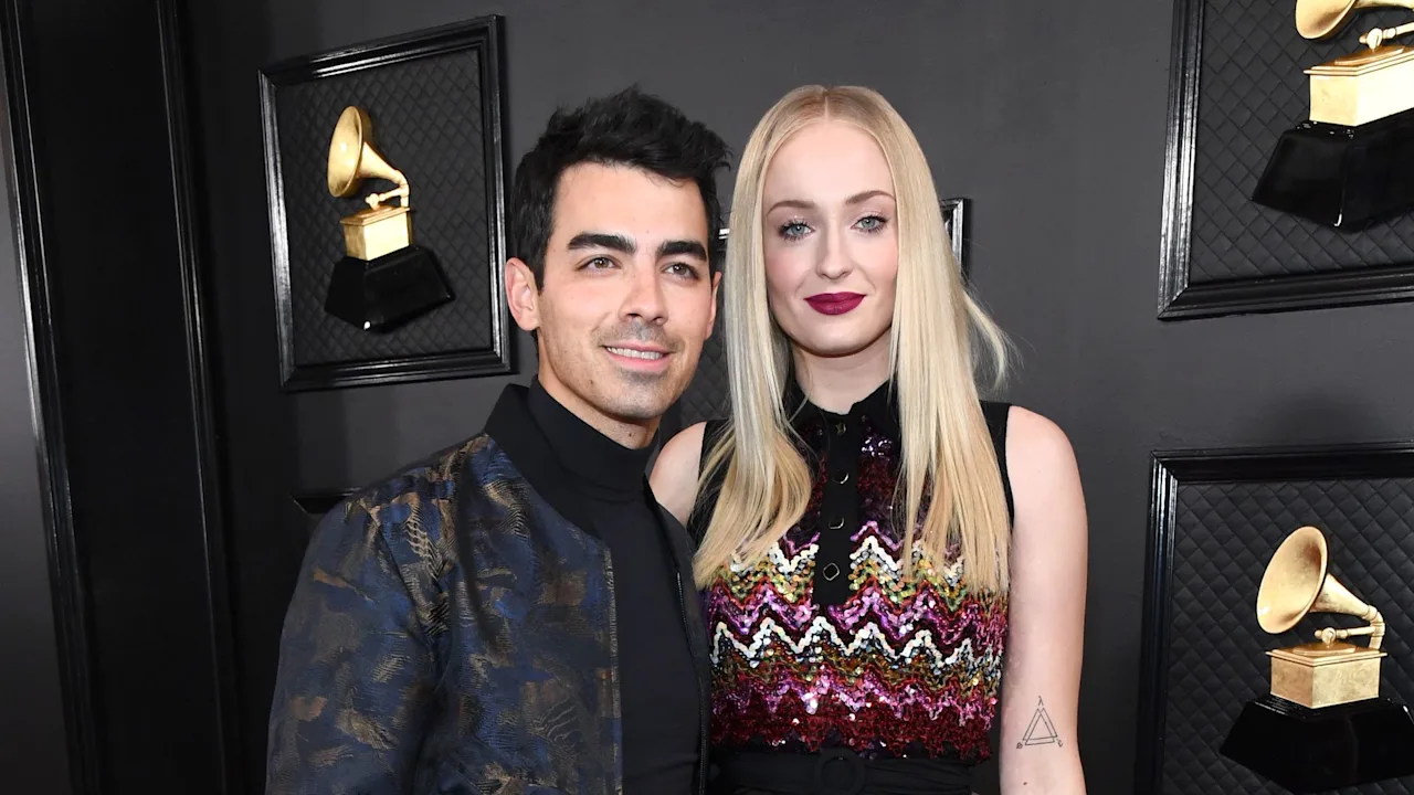 Joe Jonas and Sophie Turner posing together at a red carpet event.