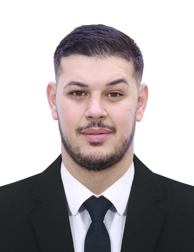 Adam Markov, the Bulgarian national accused of theft and fraud, pictured in a formal setting prior to his arrest.