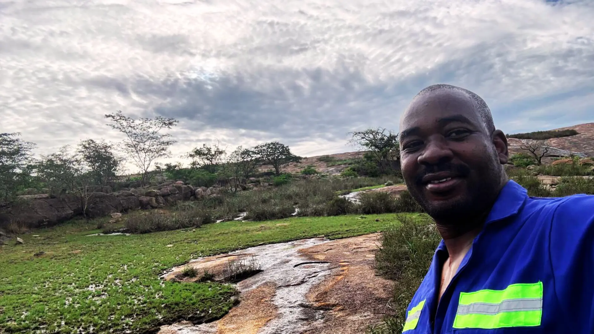 Nelson Chamisa visiting a serene countryside location, embracing grassroots connection with nature.