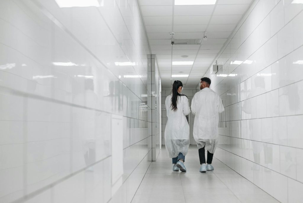 Photo by Pavel Danilyuk: https://www.pexels.com/photo/scientists-walking-in-the-hallway-8442562/